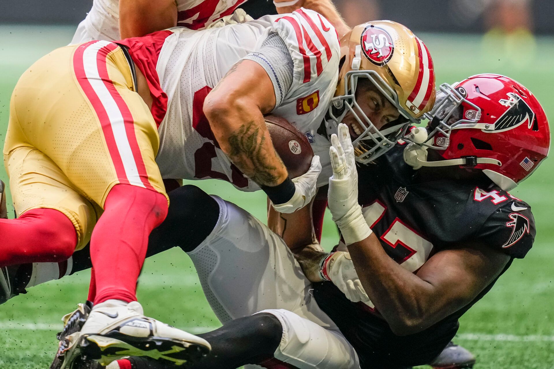 San Francisco 49ers tight end George Kittle (85) is tackled by Atlanta Falcons defensive end Arnold Ebiketie (47) during the second half at Mercedes-Benz Stadium.