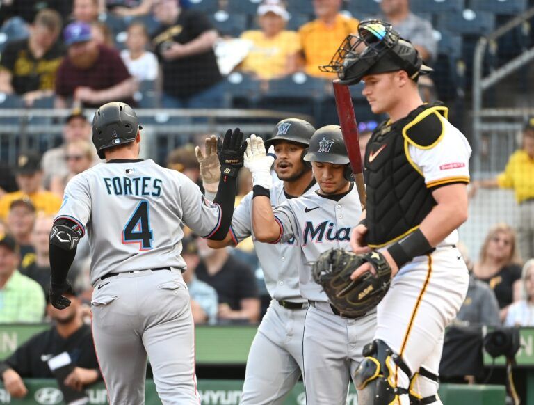 The Miami Marlins Nick Fortes is greeted at home by teammates Dane Myers (center) and Javier Sanoja near Pittsburgh Pirates catcher Henry Davis during the third inning at PNC Park.