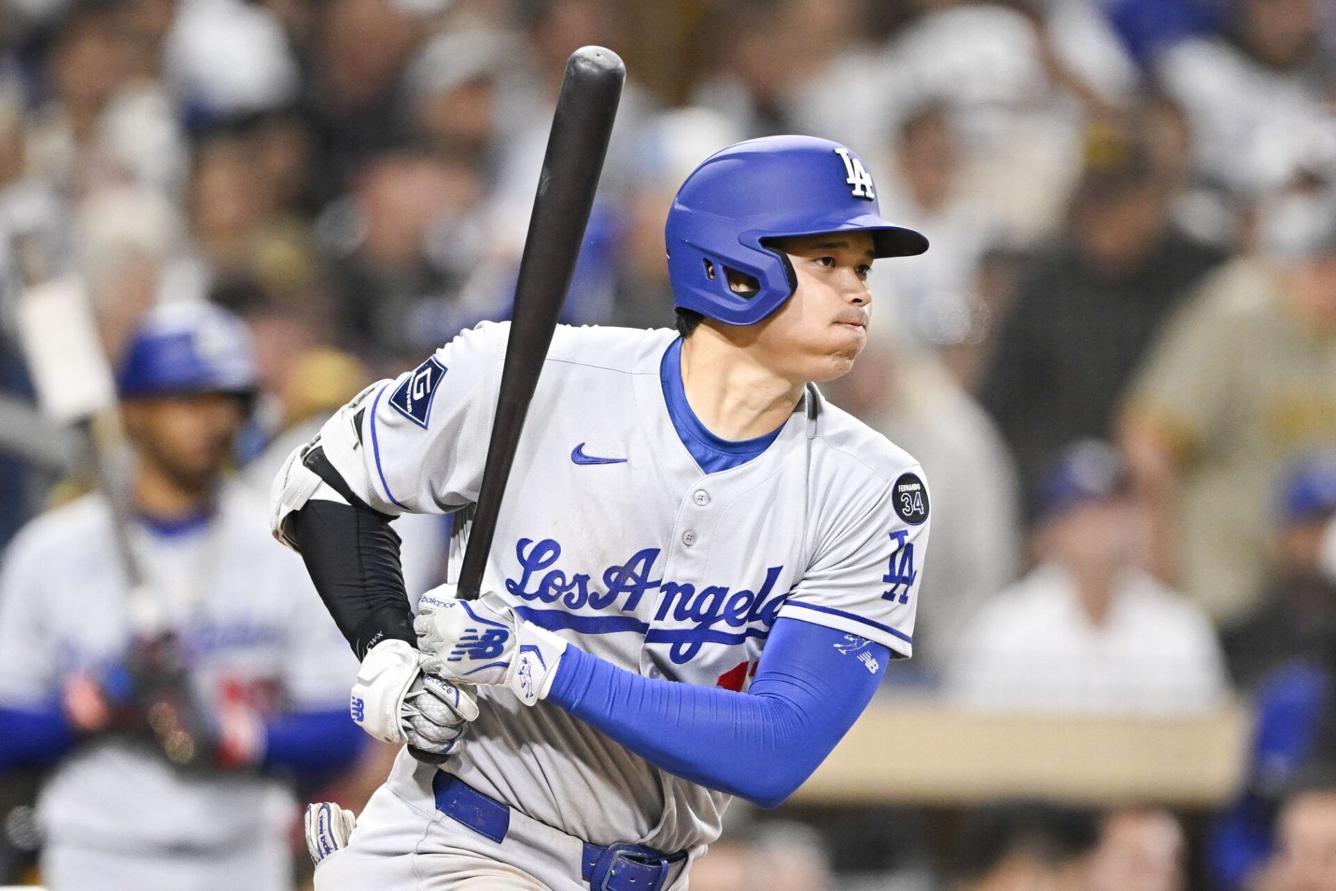 Los Angeles Dodgers designated hitter Shohei Ohtani (17) hits a single during the fifth inning against the San Diego Padres at Petco Park.