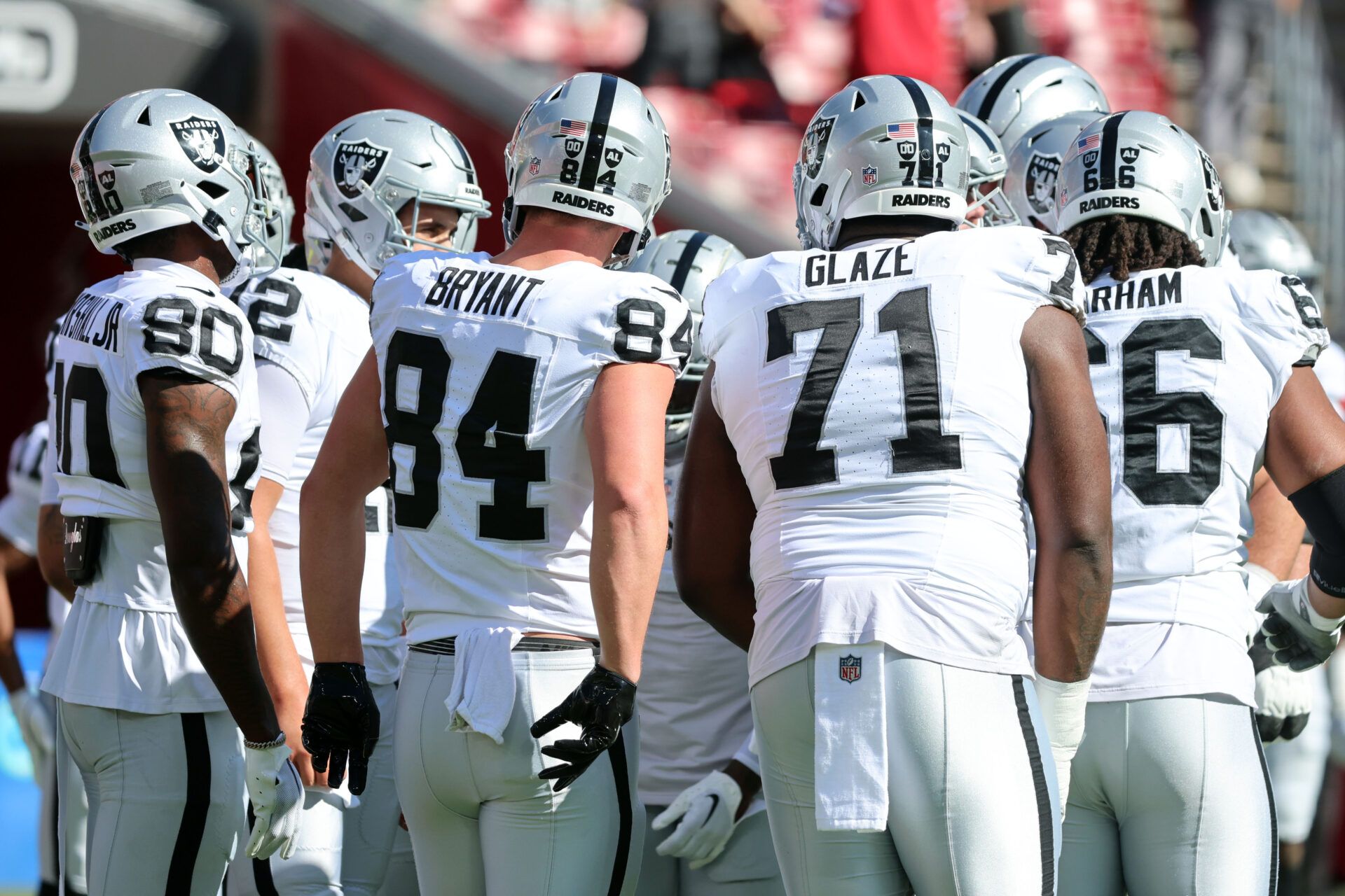 Las Vegas Raiders quarterback Aidan O'Connell (12) and teammates huddle up before the game against the Tampa Bay Buccaneers at Raymond James Stadium.