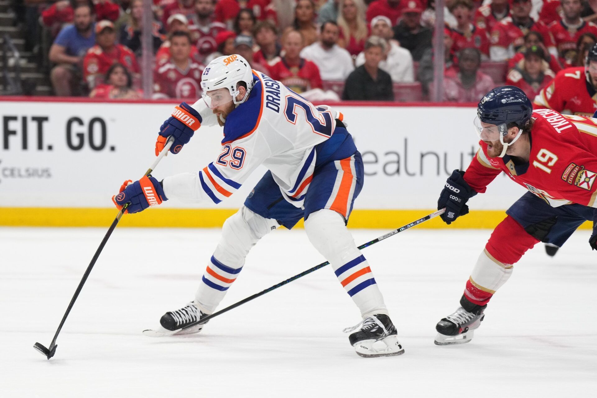 Edmonton Oilers center Leon Draisaitl (29) battles for the puck against Florida Panthers forward Matthew Tkachuk (19) during the third period in game four of the 2025 Stanley Cup Final at Amerant Bank Arena.