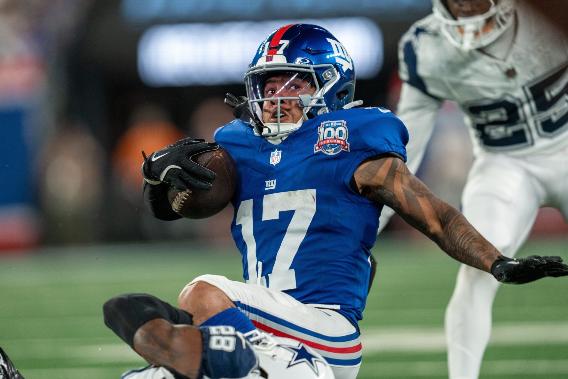 New York Giants wide receiver Wan'Dale Robinson (17) is tackled by Dallas Cowboys safety Malik Hooker (28) after catching a pass at MetLife Stadium.