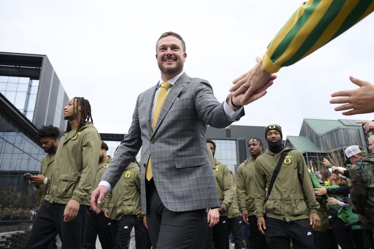 Oregon Ducks head coach Dan Lanning high-fives fans before a game against the Maryland Terrapins at Autzen Stadium.
