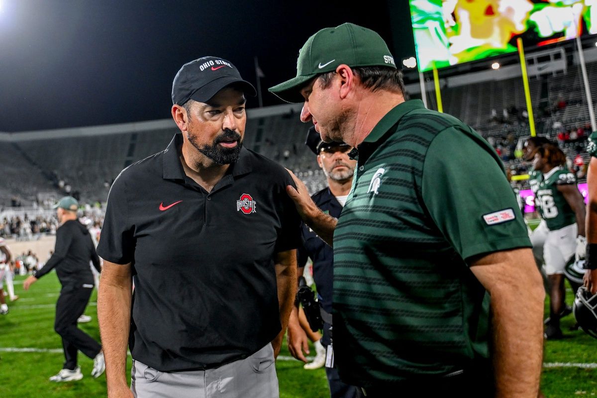 Michigan State's head coach Jonathan Smith, right, talks with Ohio State's head coach Ryan Day after the game on Saturday, Sept. 28, 2024, at Spartan Stadium in East Lansing.