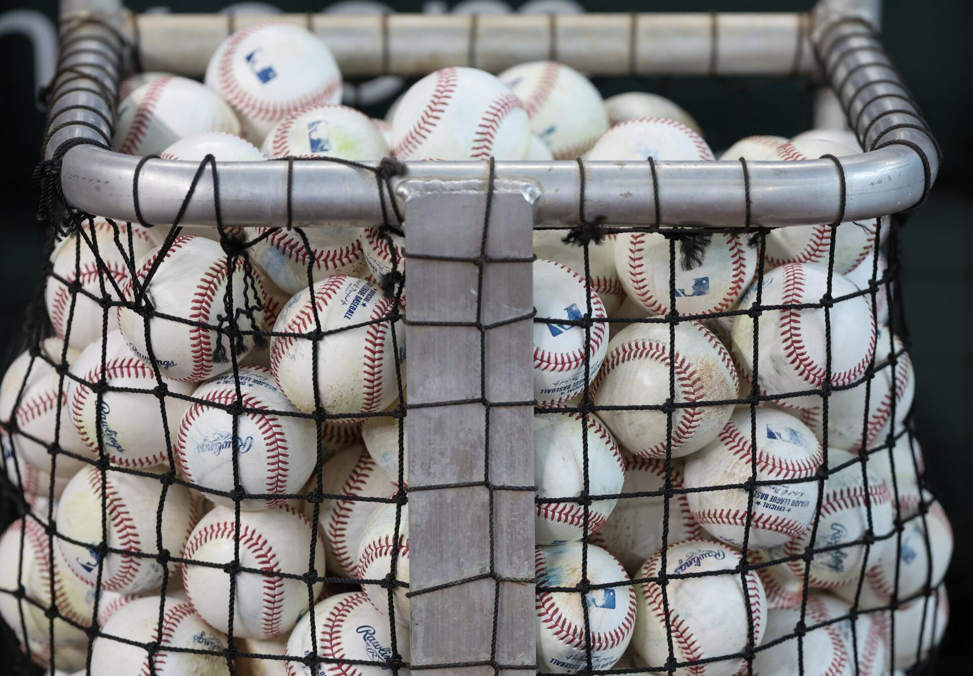 A basket of MLB baseballs are seen as the Houston Astros take batting practice before playing against the Chicago White Sox at Daikin Park.