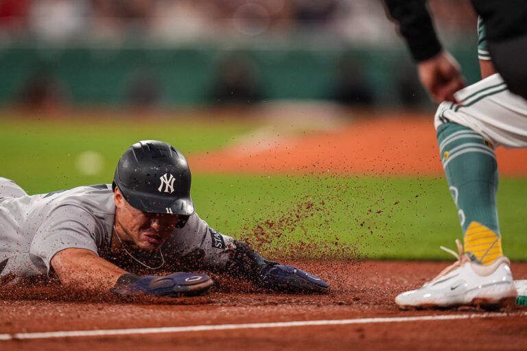 New York Yankees shortstop Anthony Volpe (11) out at third base against Boston Red Sox third base Marcelo Mayer (39) in the tenth inning at Fenway Park.
