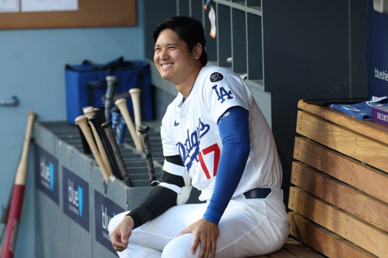 Los Angeles Dodgers designated hitter Shohei Ohtani (17) looks on in the dugout before the game against the San Francisco Giants at Dodger Stadium.