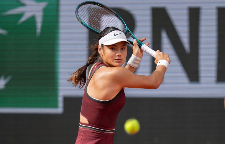Emma Raducanu of Great Britain returns a shot during her match against Iga Swiatek of Poland on day four at Roland Garros Stadium.