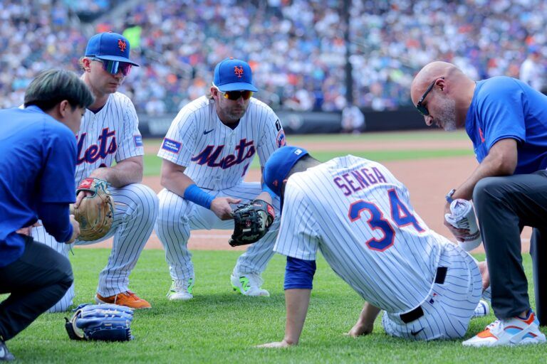 New York Mets first baseman Pete Alonso (20) and second baseman Jeff McNeil (1) watch as starting pitcher Kodai Senga (34) is tended to after sustaining an injury during the sixth inning against the Washington Nationals at Citi Field.