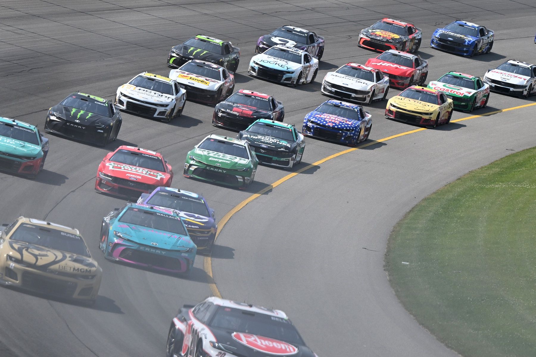 The field accelerates through turn one on a restart in stage two of FireKeepers Casino 400 at Michigan International Speedway.