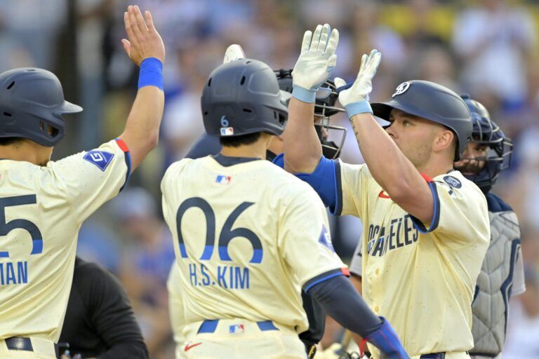 Los Angeles Dodgers catcher Dalton Rushing (68) is greeted at the plate after hitting his first major league home run, a three-run home shot, in the eighth inning against the New York Yankees at Dodger Stadium.