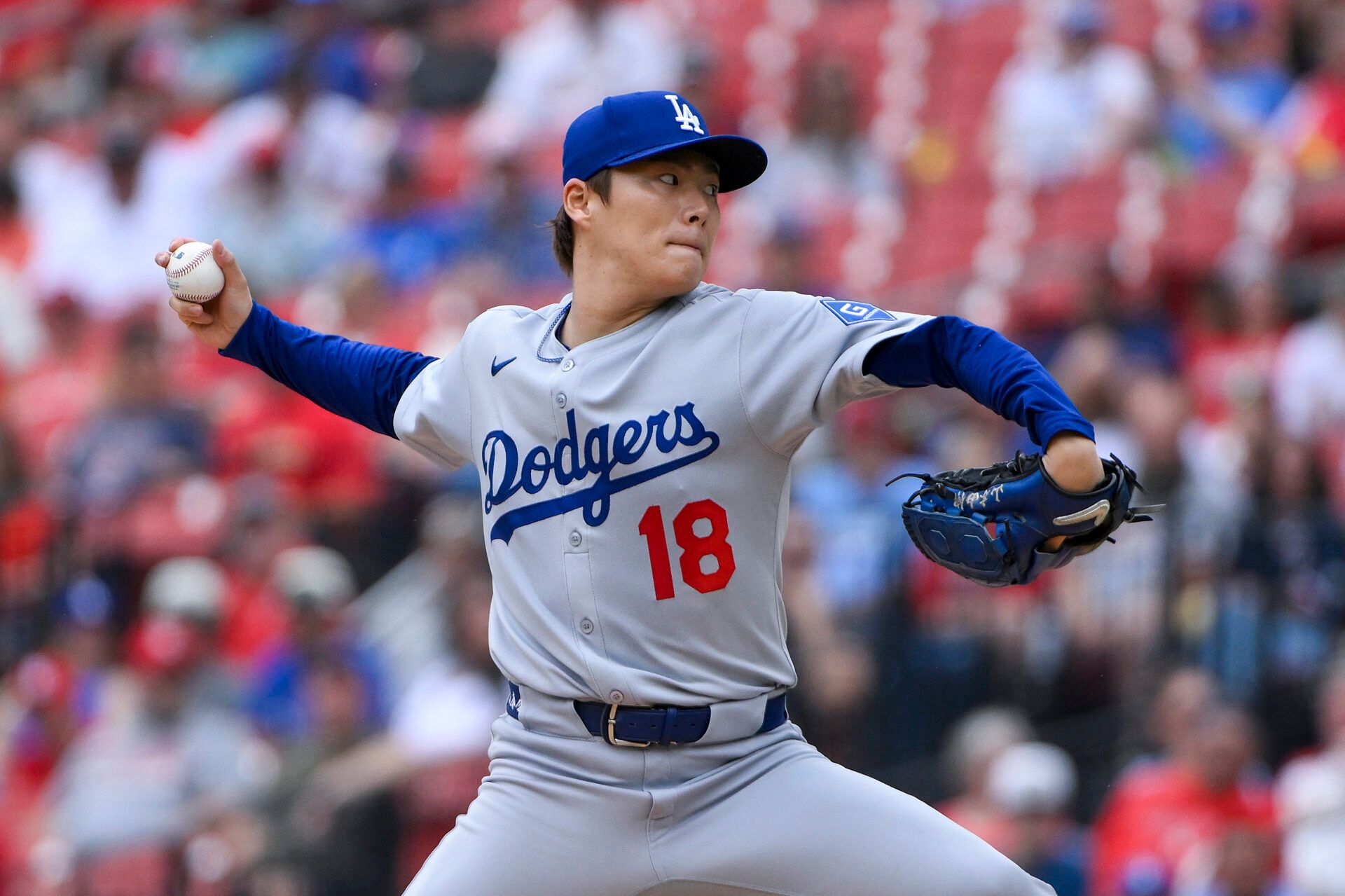 Los Angeles Dodgers starting pitcher Yoshinobu Yamamoto (18) pitches against the St. Louis Cardinals during the first inning at Busch Stadium.