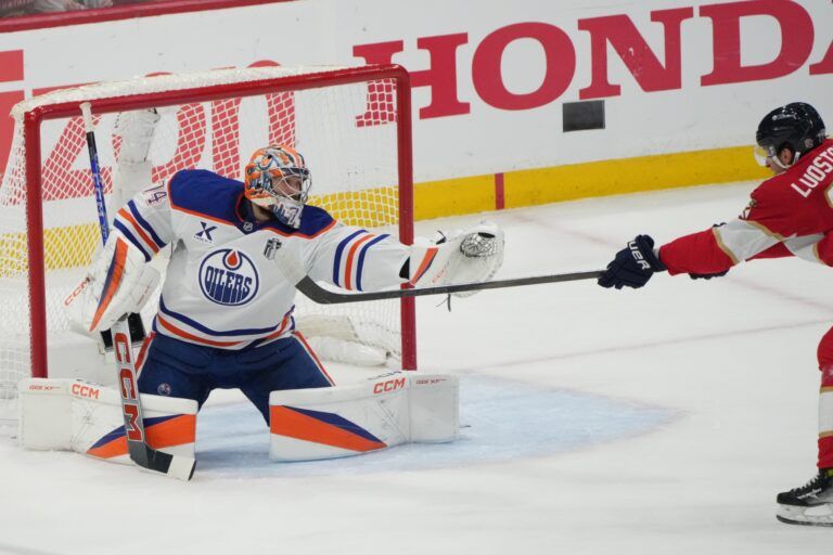 Edmonton Oilers goaltender Stuart Skinner (74) blocks a shot by Florida Panthers forward Eetu Luostarinen (27) during the first period in game four of the 2025 Stanley Cup Final at Amerant Bank Arena.