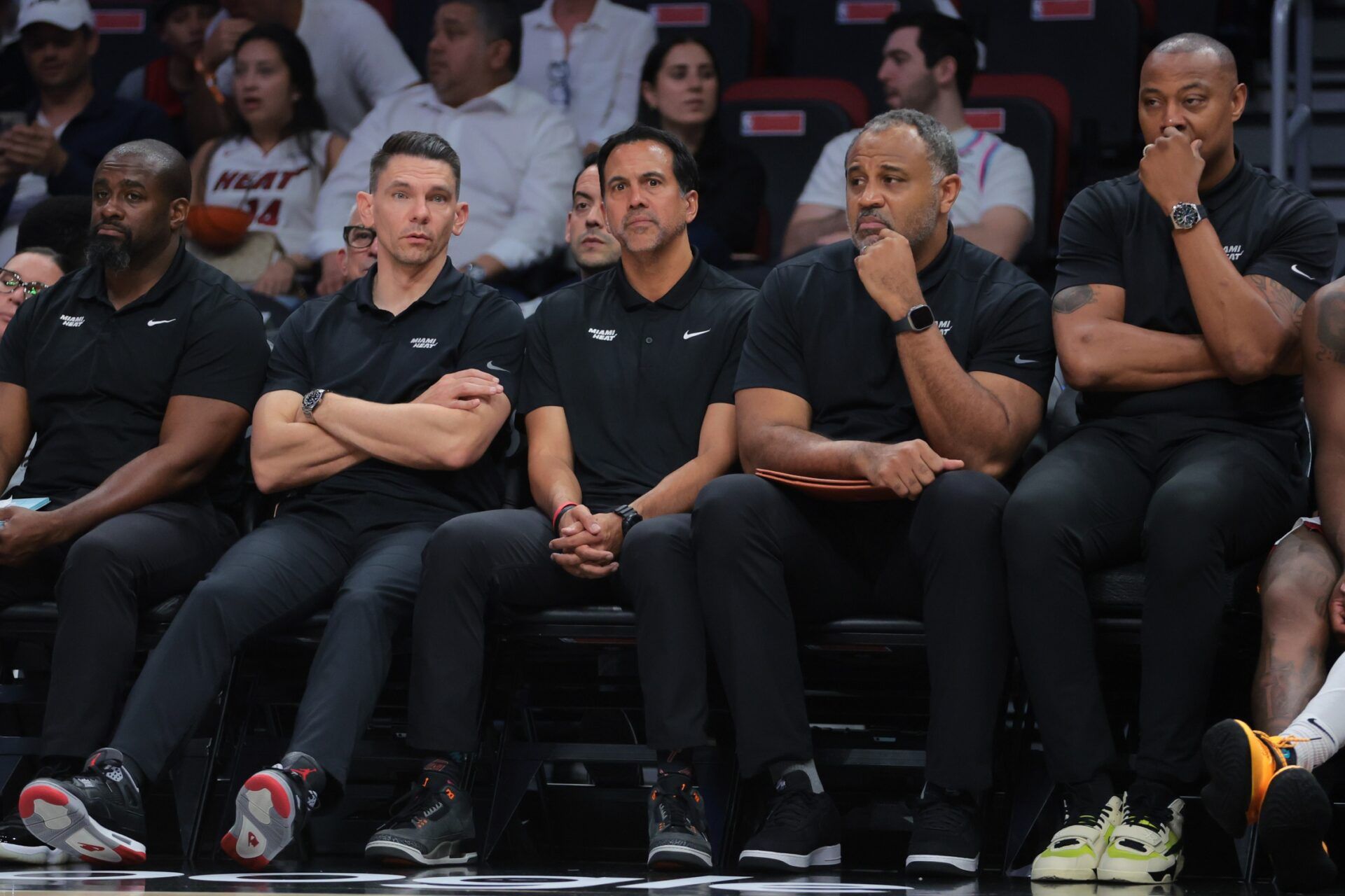 Miami Heat associate head coach Chris Quinn (left), head coach Erik Spoelstra (center), assistant coach Malik Allen and assistant coach Caron Butler (right) look on from the bench against the Cleveland Cavaliers in the fourth quarter during game four for the first round of the 2025 NBA Playoffs at Kaseya Center.