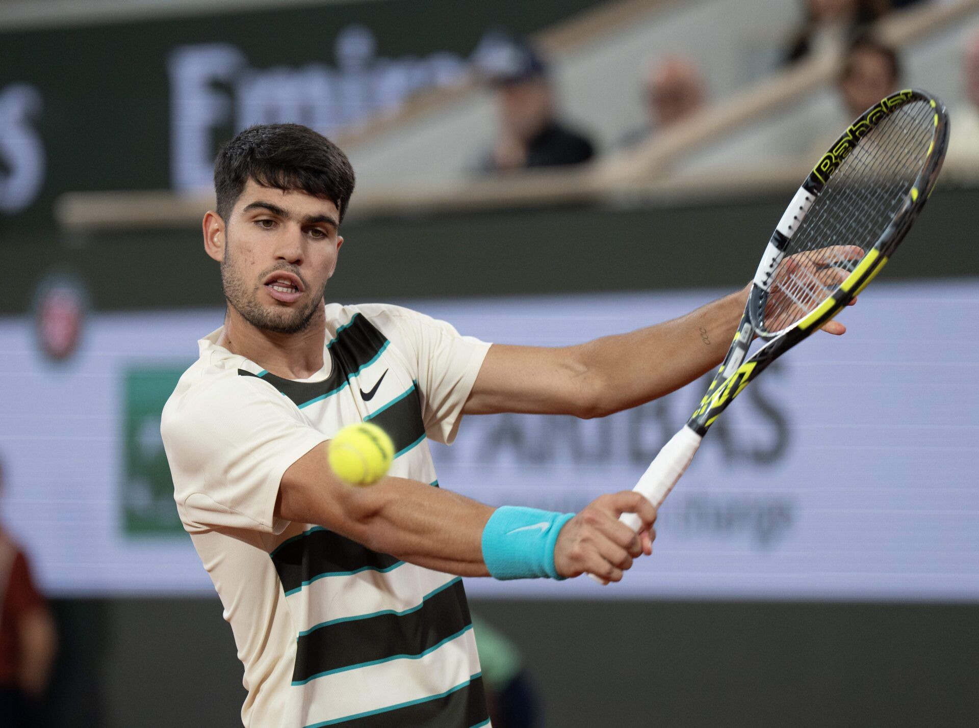 Carlos Alcaraz of Spain returns a shot during his match against Lorenzo Musetti of Italy match on day 13 at Roland Garros Stadium.