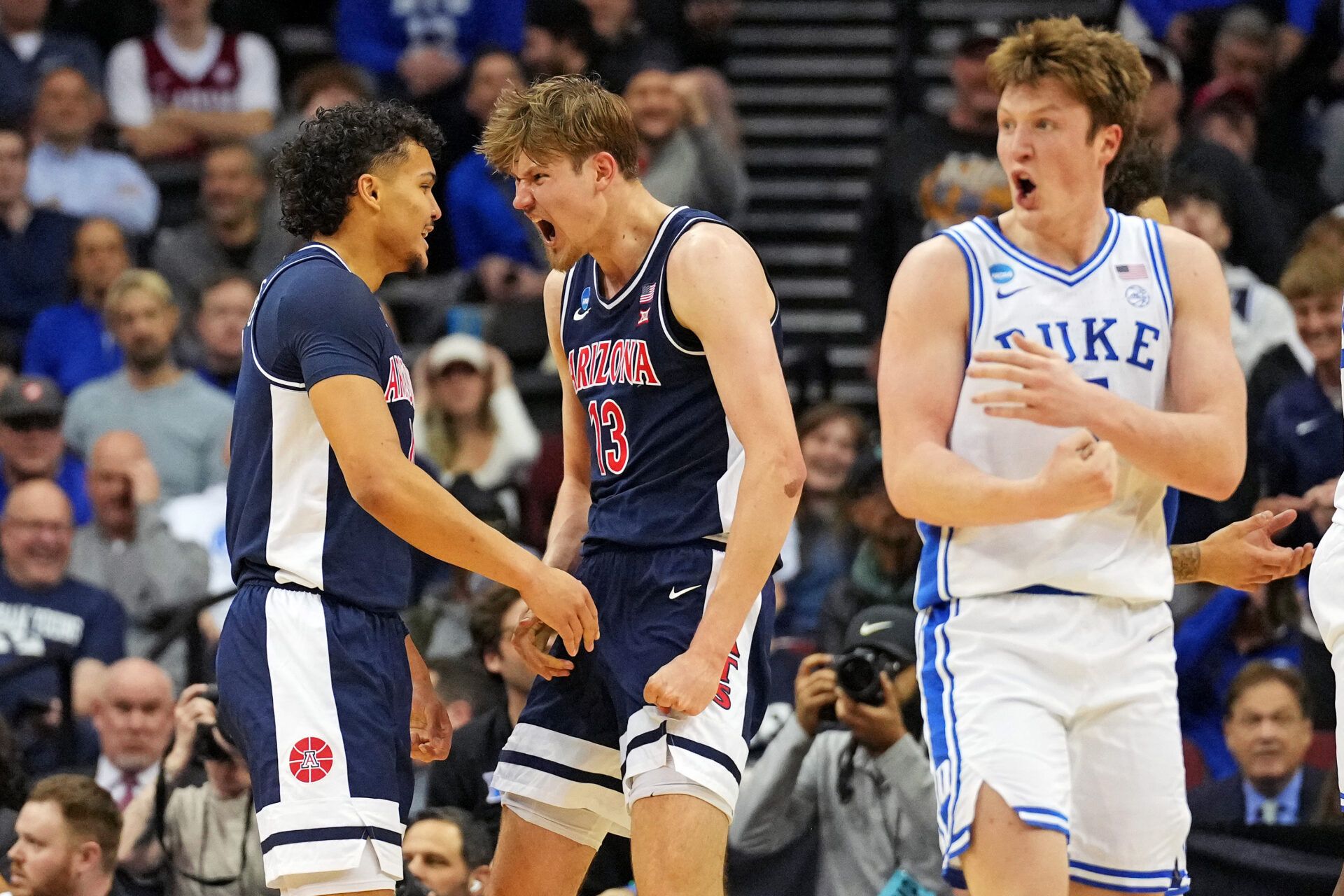 Arizona Wildcats forward Henri Veesaar (13) celebrates with Arizona Wildcats forward Trey Townsend (4) after a play against the Duke Blue Devils during the second half during an East Regional semifinal of the 2025 NCAA tournament at Prudential Center.