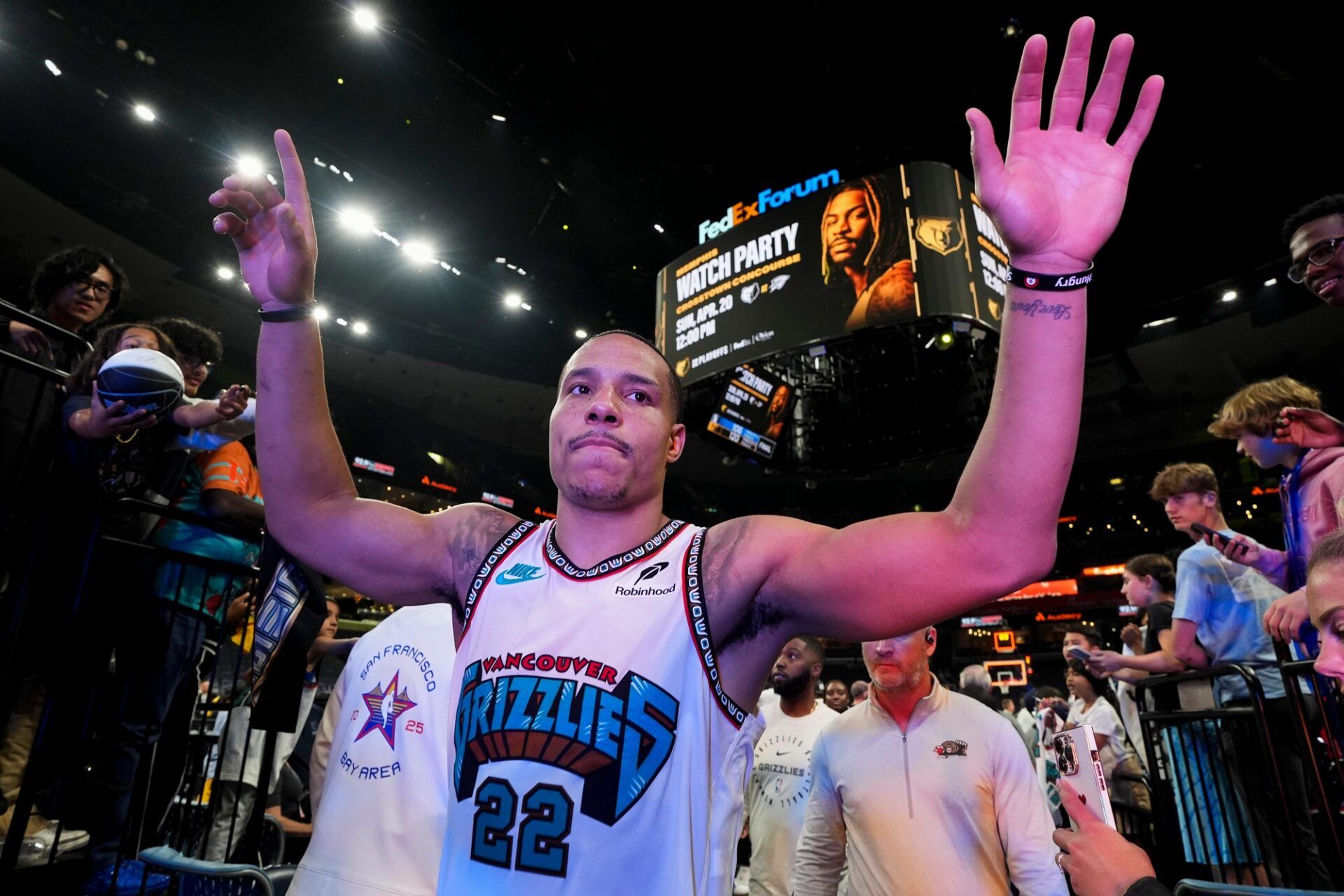 Grizzlies' Desmond Bane (22) high fives fans as he walks off the court after the Grizzlies defeated the Mavericks 120-106 in the play-in game to secure a spot in the NBA Playoffs at FedExForum in Memphis, Tenn., on Friday, April 18, 2025.