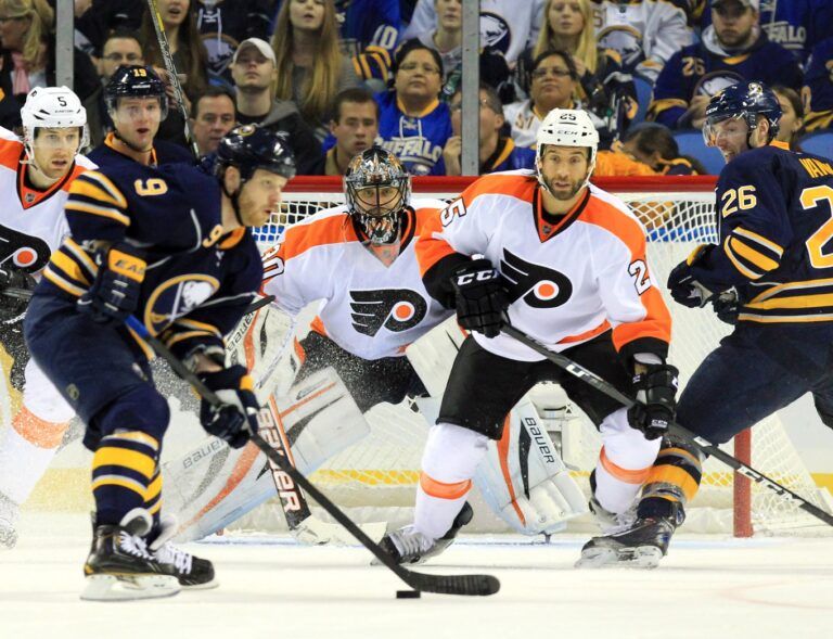 Philadelphia Flyers goalie Ilya Bryzgalov (30) is screened but watches as Buffalo Sabres center Steve Ott (9) take the puck during the third period at the First Niagara Center. Sabres beat the Flyers 5-2.