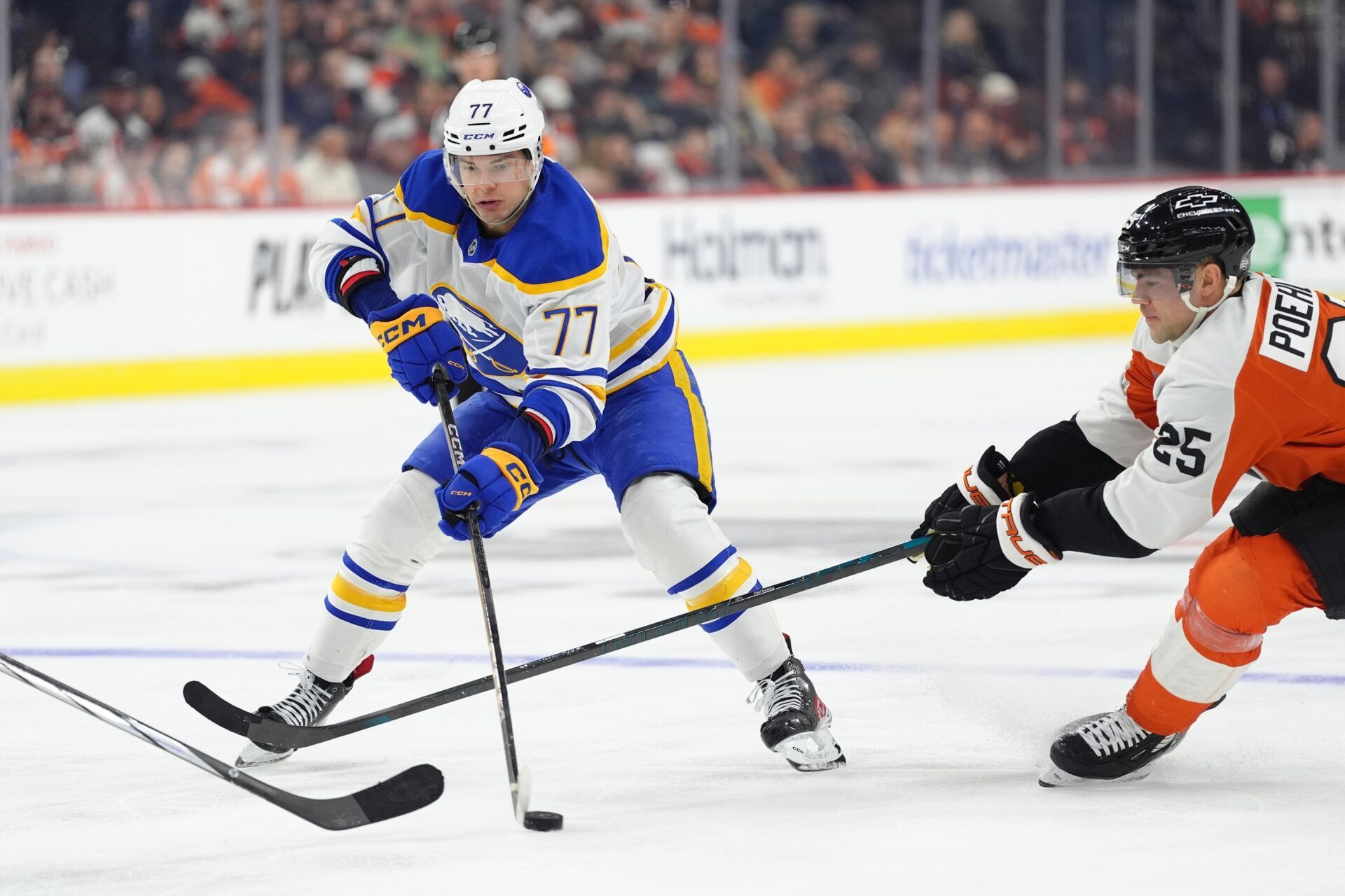 Buffalo Sabres right wing JJ Peterka (77) controls the puck against Philadelphia Flyers center Ryan Poehling (25) in the third period at Wells Fargo Center.