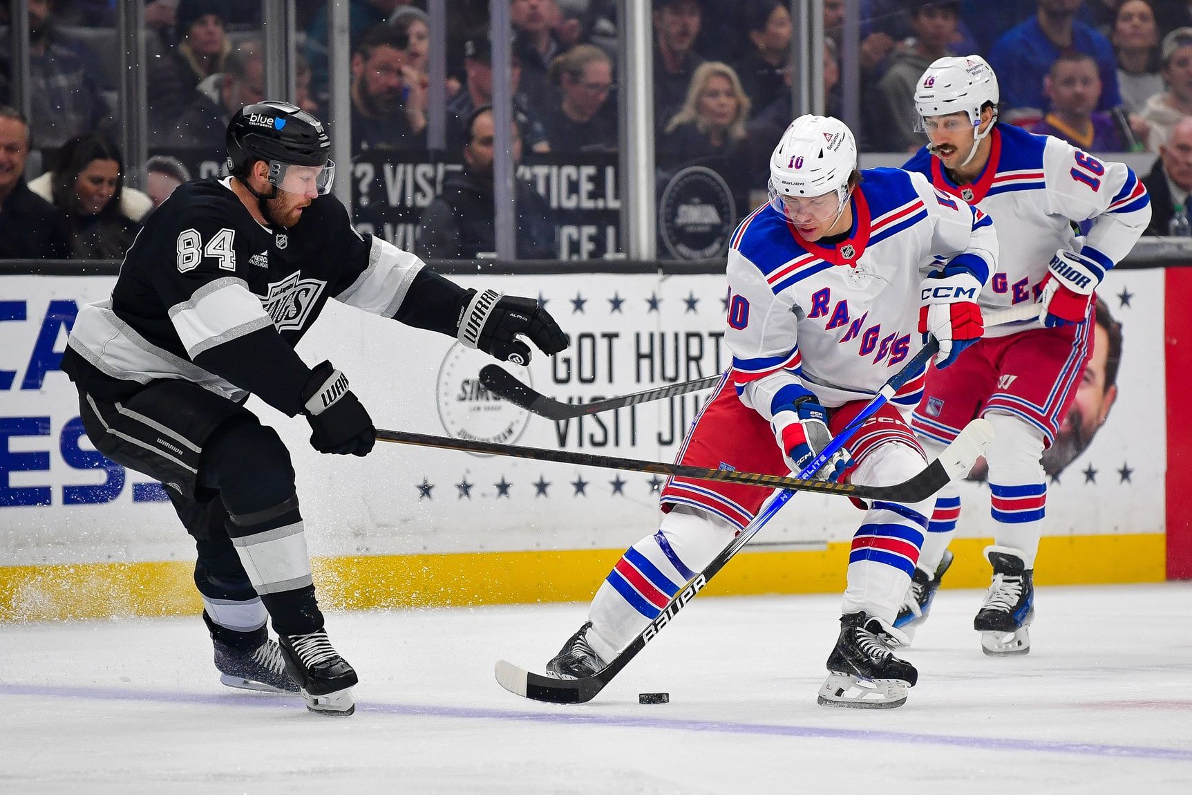 Los Angeles Kings defenseman Vladislav Gavrikov (84) plays for the puck against New York Rangers left wing Artemi Panarin (10)  foduring the first period at Crypto.com Arena.