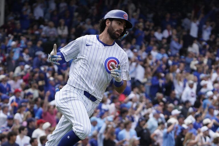 Chicago Cubs shortstop Dansby Swanson (7) gestures after hitting a home run against the Pittsburgh Pirates during the sixth inning at Wrigley Field.