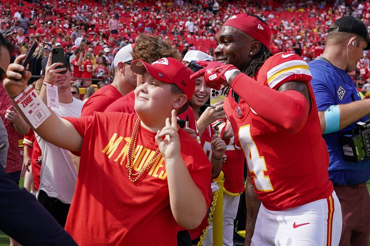 Kansas City Chiefs wide receiver Rashee Rice (4) poses for photos with fans prior to a game against the Cincinnati Bengals at GEHA Field at Arrowhead Stadium.