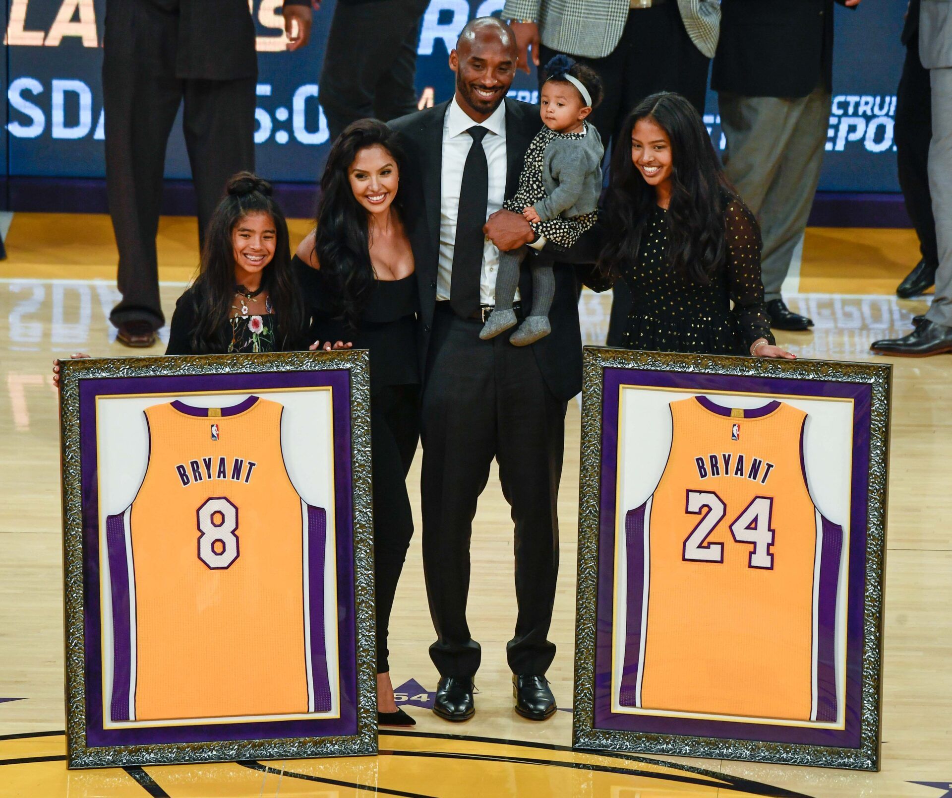 Kobe Bryant (center) poses with his family Gianna Bryant, Vanessa Bryant, Bianka Bryant, and Natalia Bryant during a halftime ceremony retiring Kobe Bryant's two uniform numbers at Staples Center.