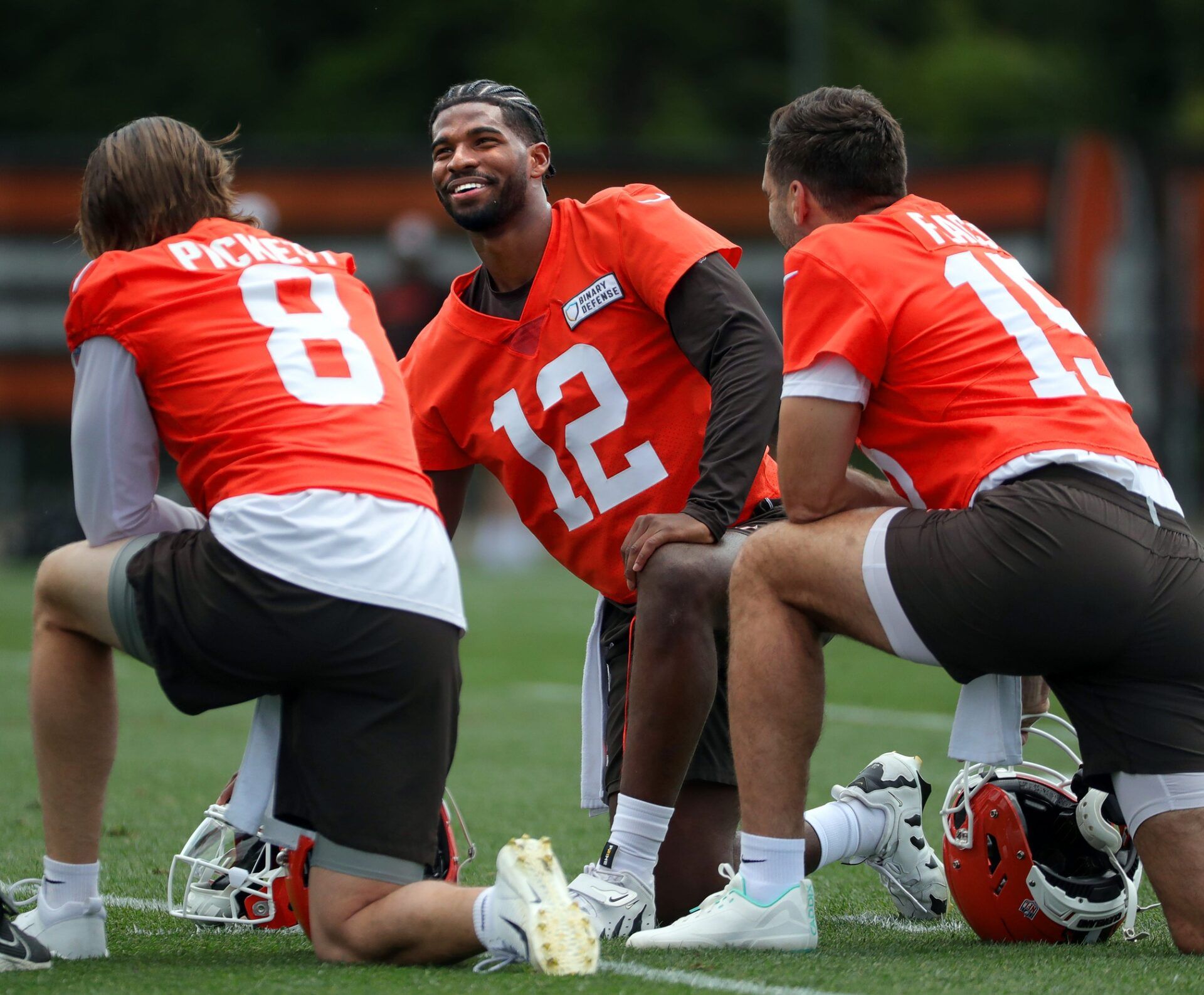 Browns quarterbacks Shedeur Sanders (12), Kenny Pickett (8) and Joe Flacco (15) talk during minicamp, Tuesday, June 10, 2025, in Berea.