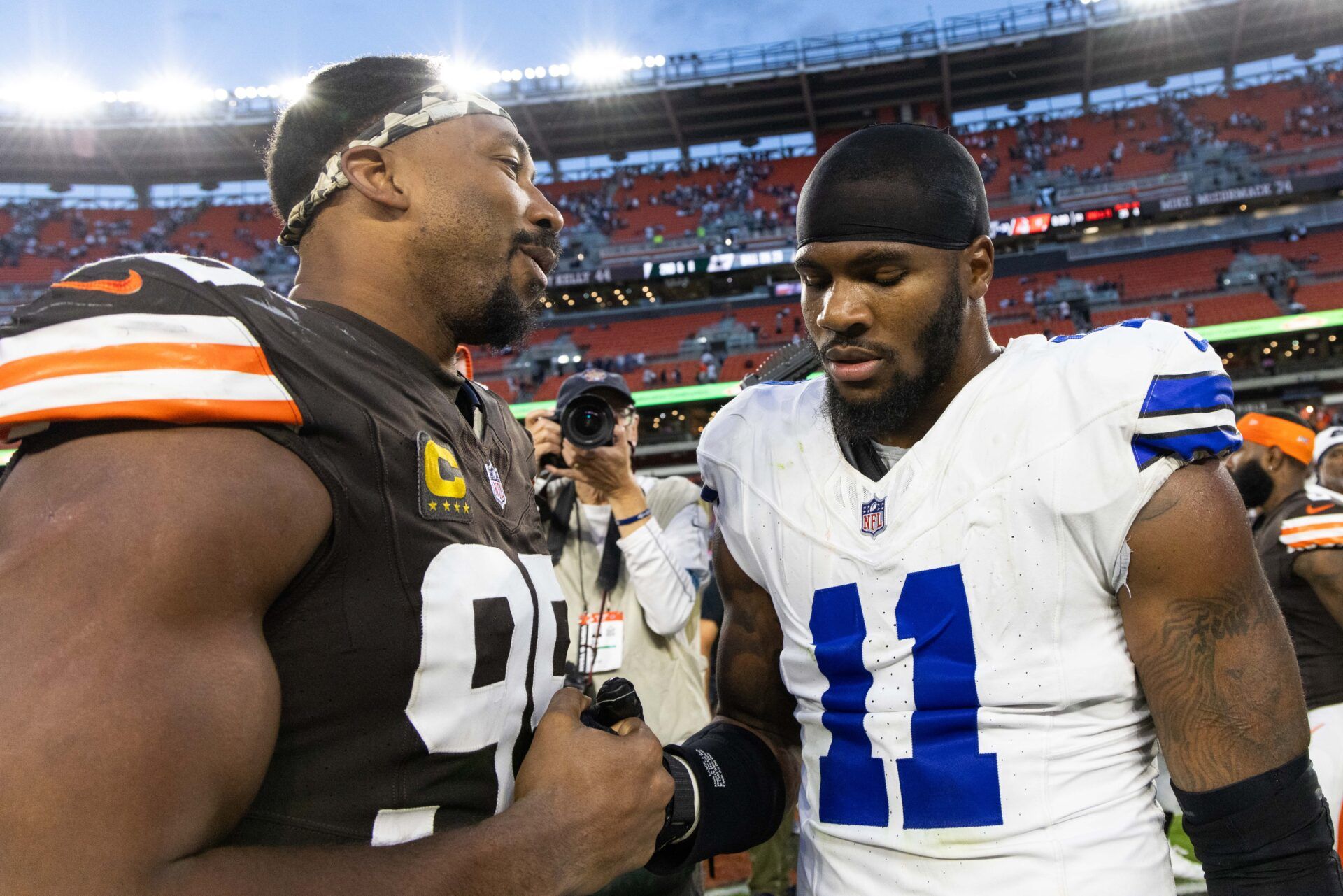 Cleveland Browns defensive end Myles Garrett (95) congratulates Dallas Cowboys linebacker Micah Parsons (11) after the game at Huntington Bank Field.