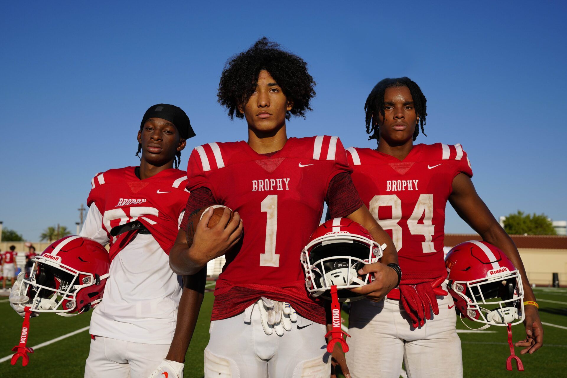 Brophy Prep wide receivers Donovan McNabb Jr. (left to right), Devin Fitzgerald and Daylen Sharper pose for a portrait during a practice at Brophy College Prepatory in Phoenix on Sept. 4, 2024.