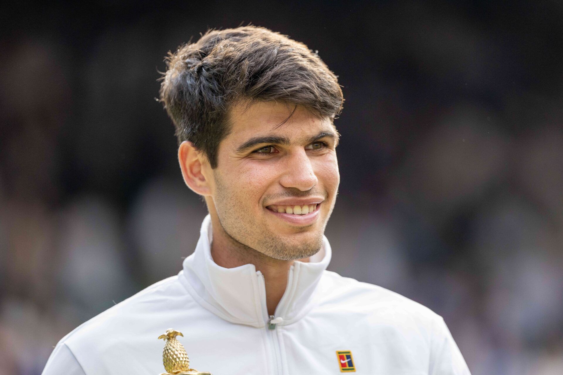 Carlos Alcaraz of Spain poses with the trophy after winning the menÕs singles match against Novak Djokovic of Serbia on day 14 at All England Lawn Tennis and Croquet Club.
