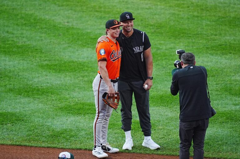 Colorado Rockies team photographer Kyle Coopah poses Baltimore Orioles second base Jackson Holliday (7) and his father retired American baseball player Matt Holliday at Coors Field.