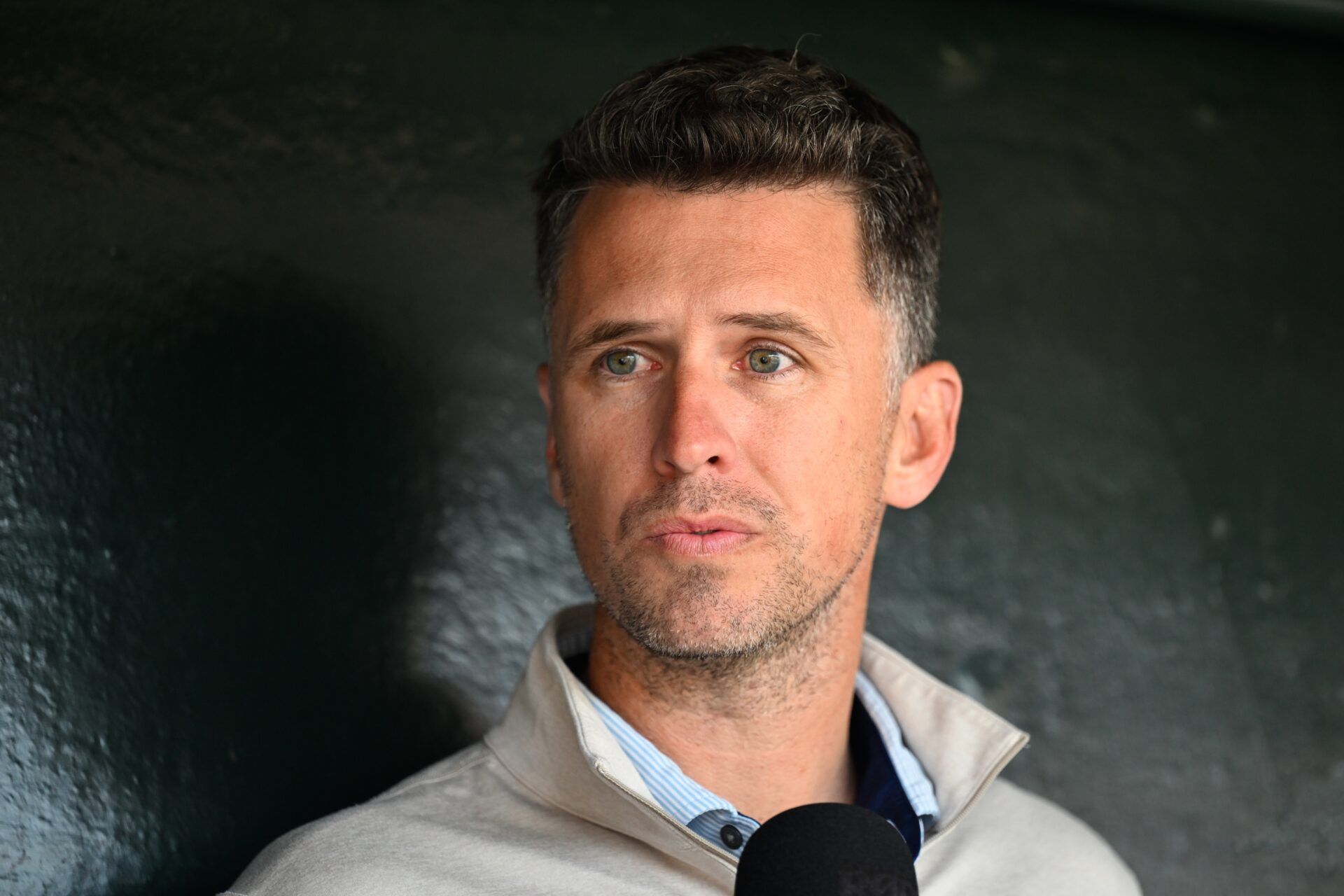 Former San Francisco Giants player Buster Posey sits in the dugout before the game against the San Diego Padres at Oracle Park.