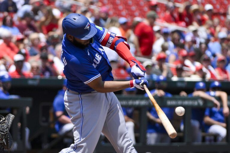 Toronto Blue Jays first baseman Vladimir Guerrero Jr. (27) hits a single against the St. Louis Cardinals during the first inning at Busch Stadium.