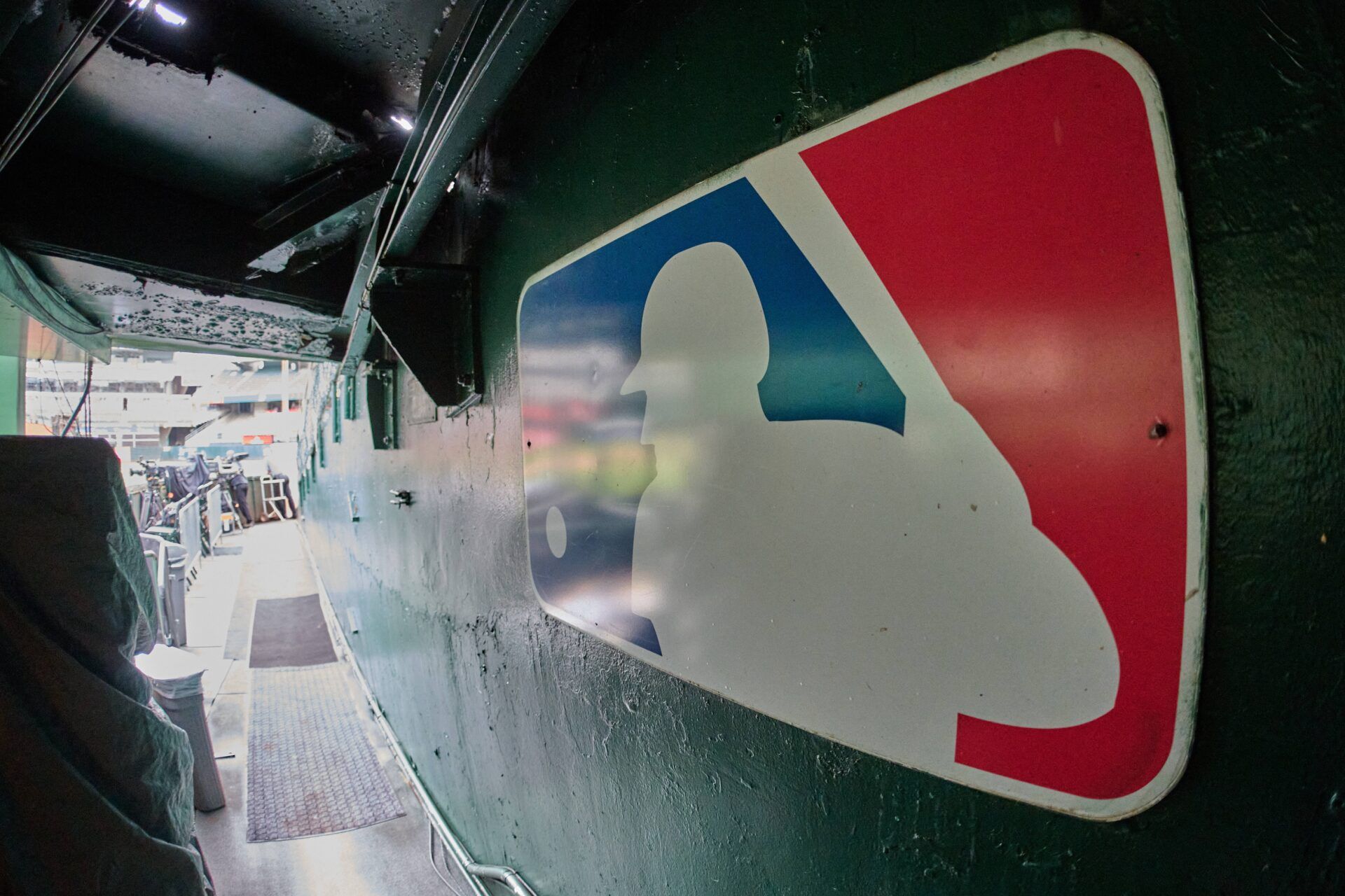 The major league baseball logo is seen on signage near the player's entrance to the field at Oakland-Alameda County Coliseum before the game between the Oakland Athletics and the Milwaukee Brewers.
