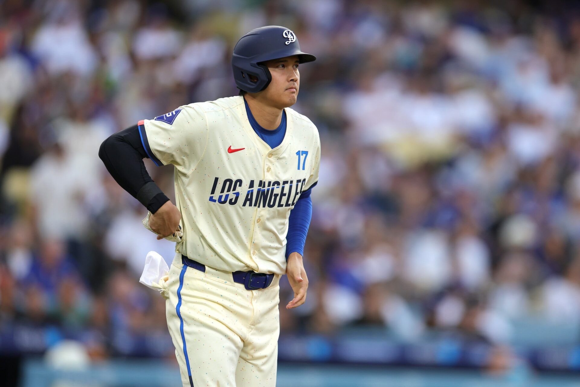 Los Angeles Dodgers two-way player Shohei Ohtani (17) reacts after a walk in the second inning against the San Francisco Giants at Dodger Stadium.