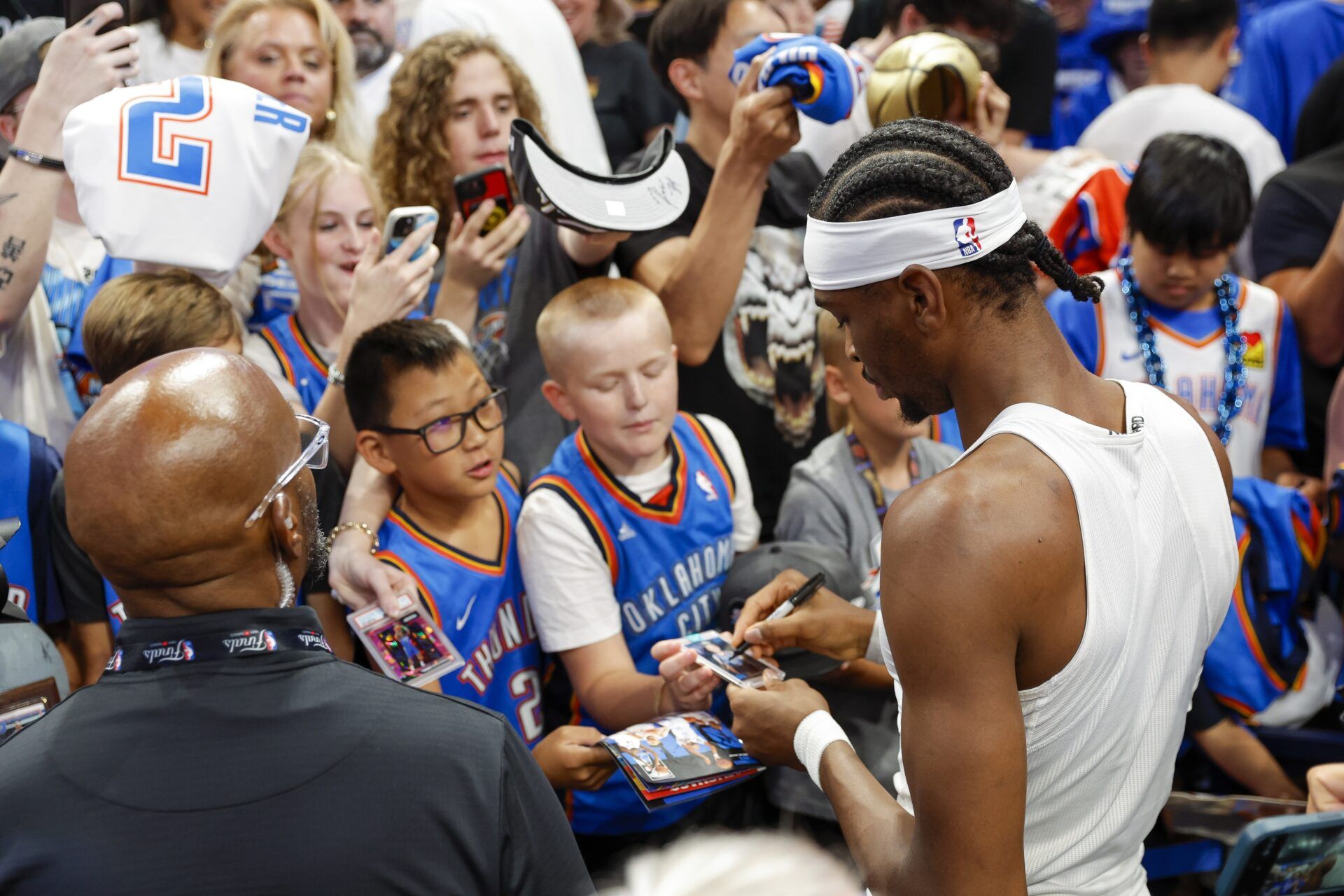 Oklahoma City Thunder guard Shai Gilgeous-Alexander (2) signs autographs for fans before the game between the Oklahoma City Thunder and the Indiana Pacers in game five of the 2025 NBA Finals at Paycom Center.