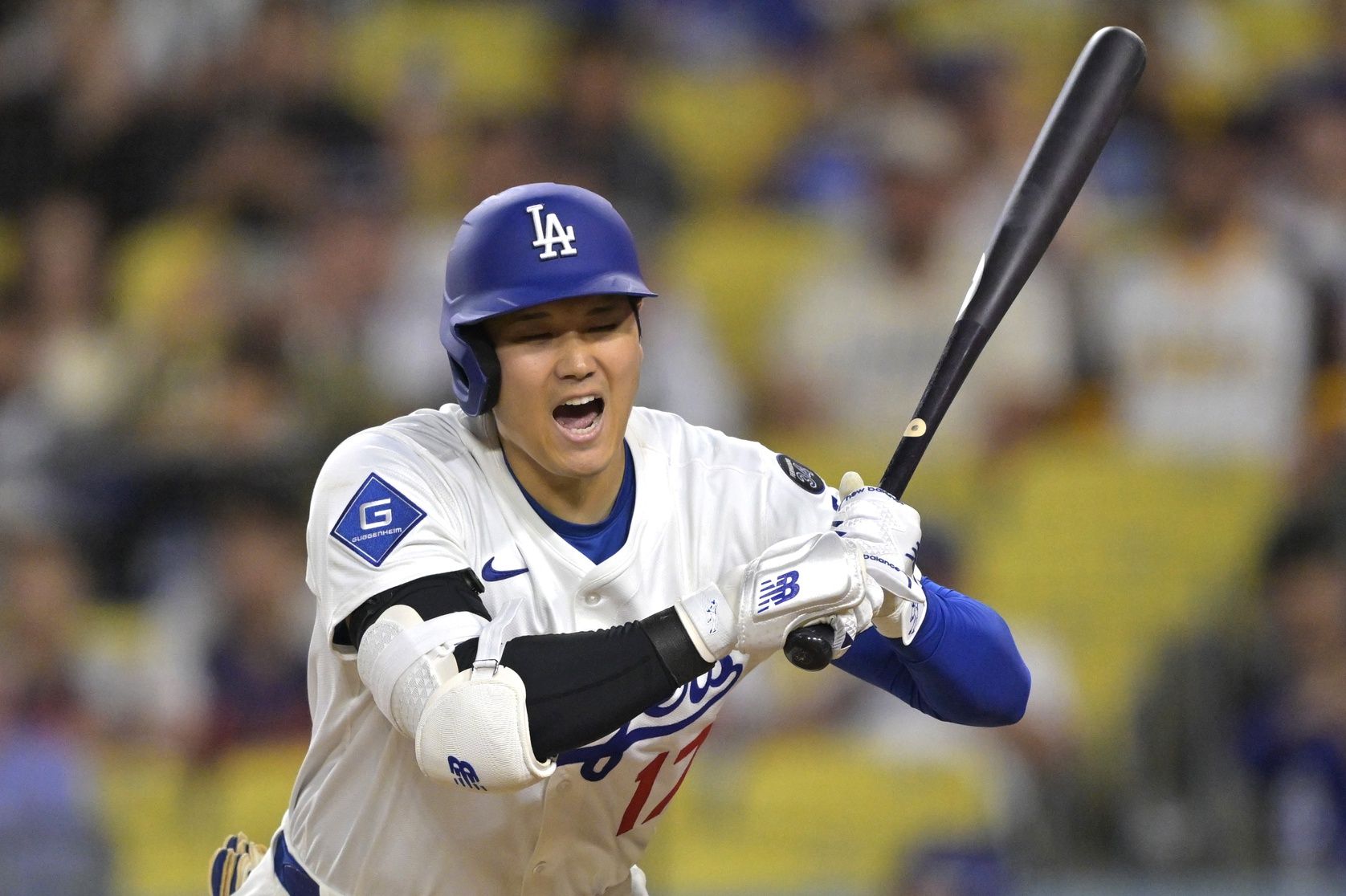 Los Angeles Dodgers designated hitter Shohei Ohtani (17) reacts to an inside pitch in the eighth inning against the San Diego Padres at Dodger Stadium.