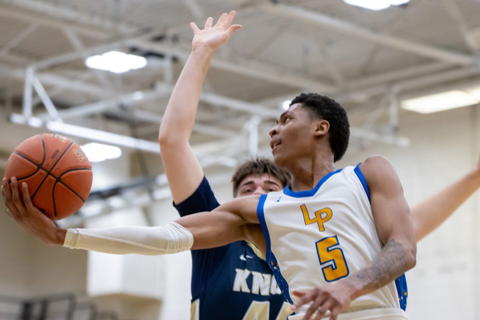 Meleek Thomas (5) goes for the acrobatic finish during the first half of play of Lincoln Park's quarterfinal victory over Knoch at UPMC Court Wednesday night.