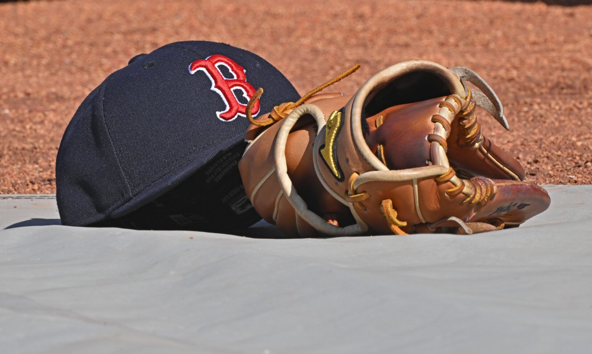 A general view of a Boston Red Sox's cap and glove on the field before a game against the Kansas City Royals at Kauffman Stadium.