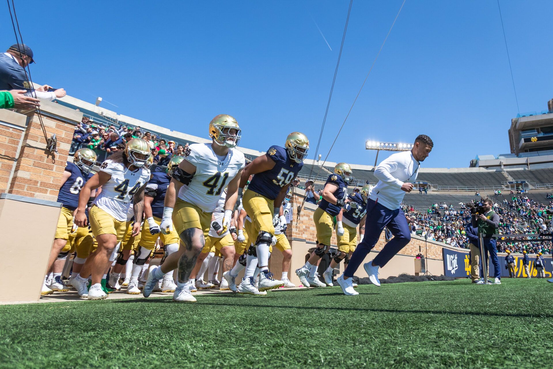 Notre Dame Fighting Irish head coach Marcus Freeman leads the team onto the field during the Blue-Gold game at Notre Dame Stadium.
