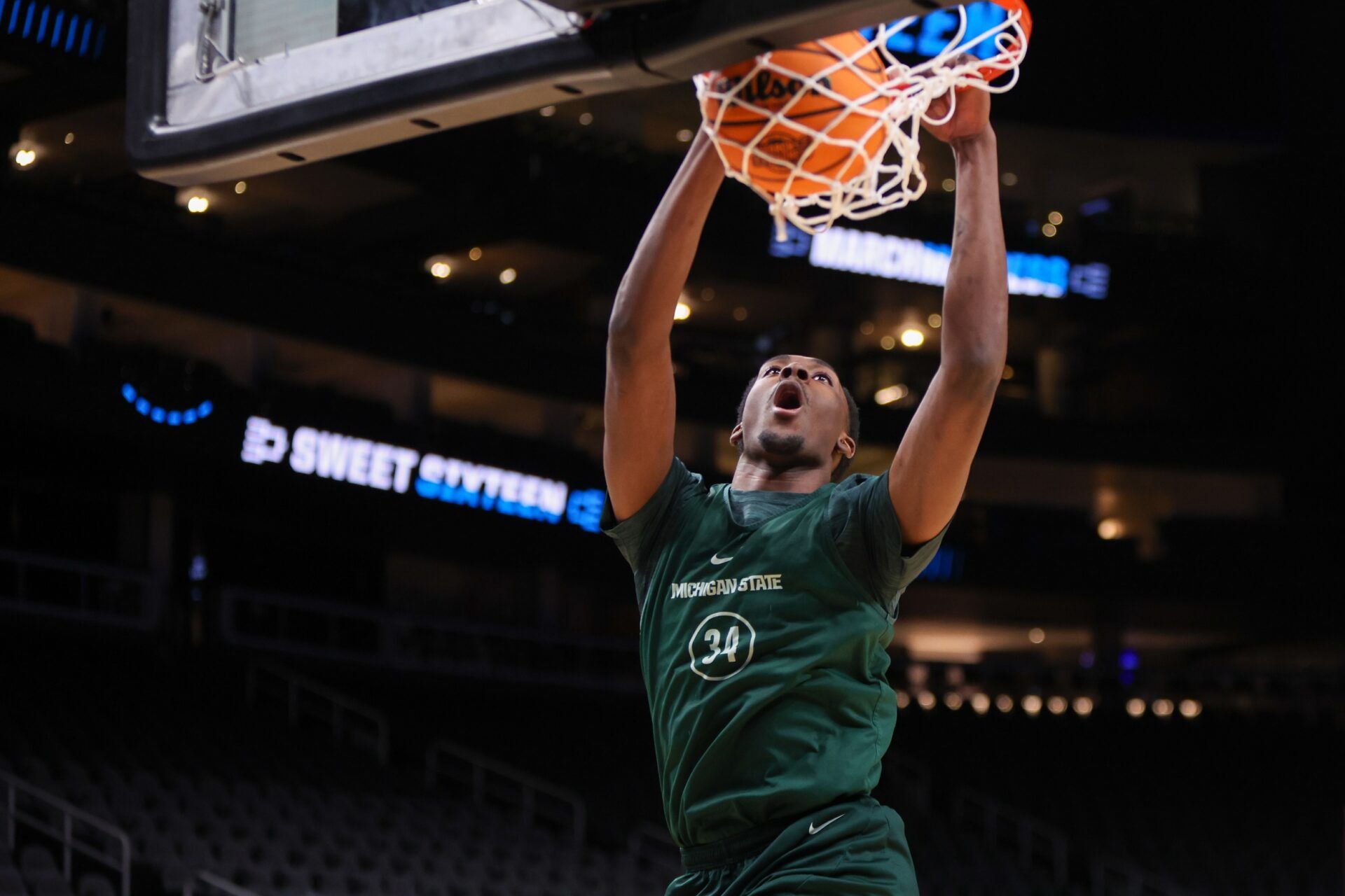 Michigan State Spartans forward Xavier Booker (34) dunks during NCAA Tournament South Regional Practice at State Farm Arena.