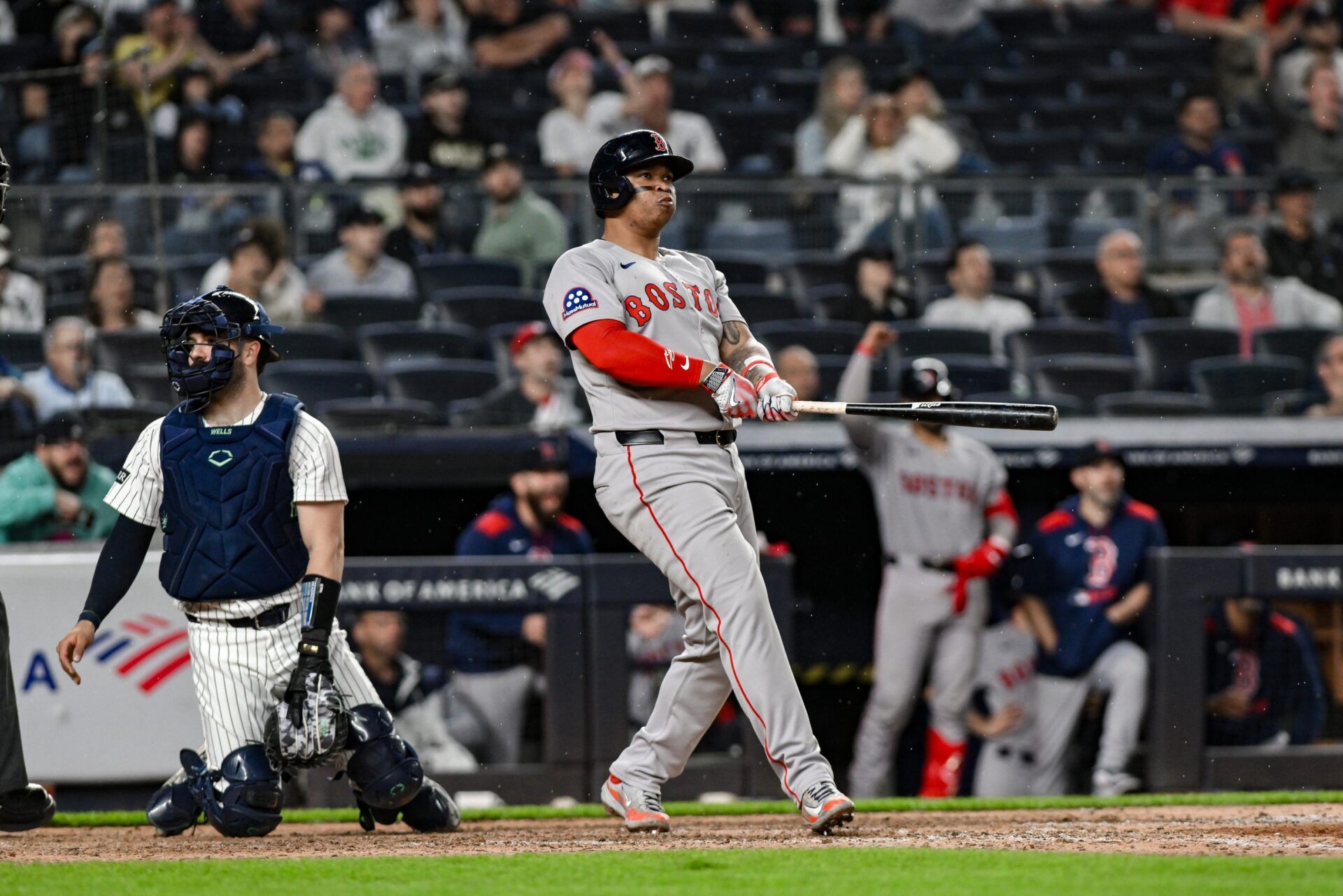 Boston Red Sox designated hitter Rafael Devers (11) reacts after hitting a solo home run against the New York Yankees during the ninth inning at Yankee Stadium.