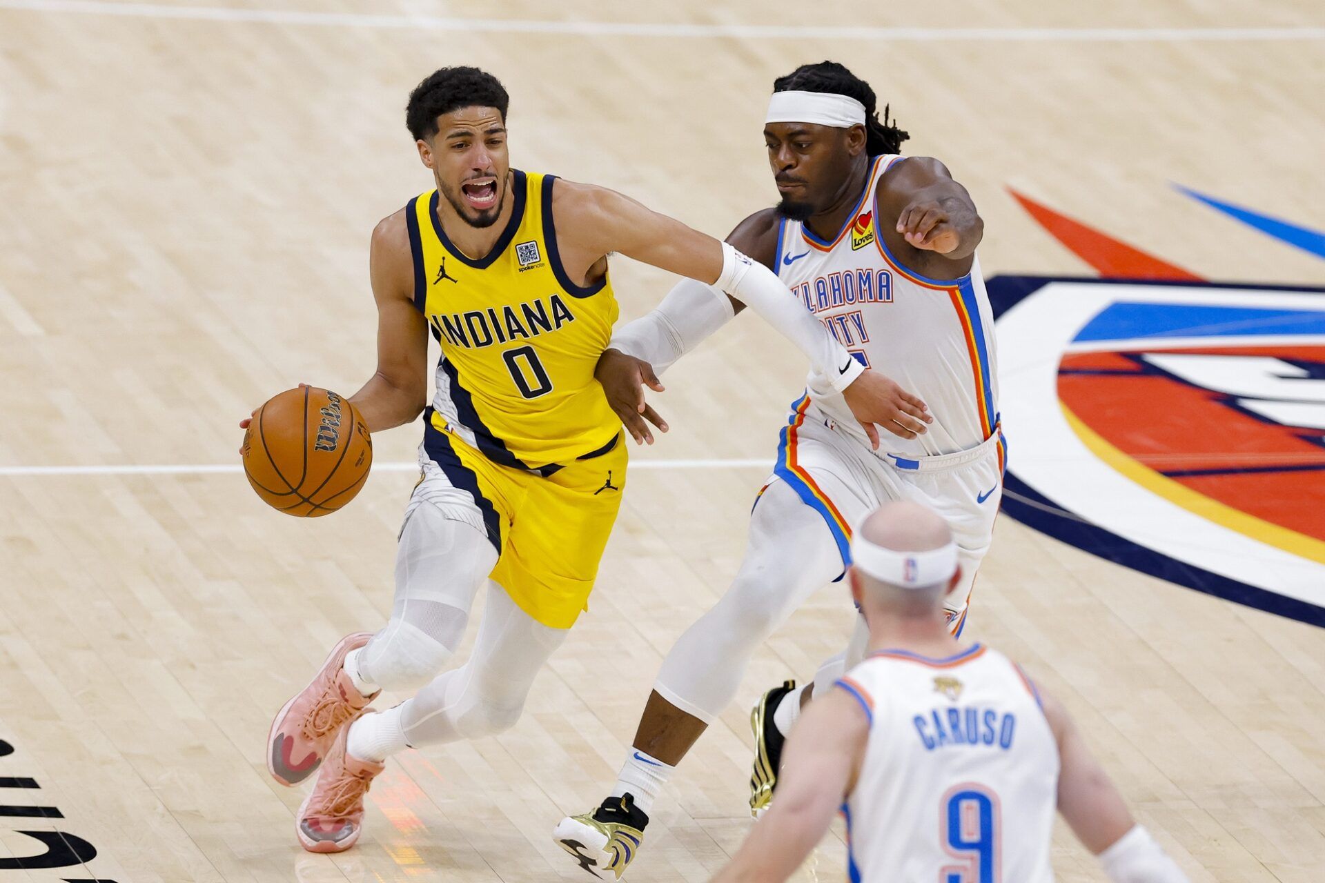 Indiana Pacers guard Tyrese Haliburton (0) drives to the basket past Oklahoma City Thunder guard Luguentz Dort (5) during the third quarter in game five of the 2025 NBA Finals at Paycom Center.