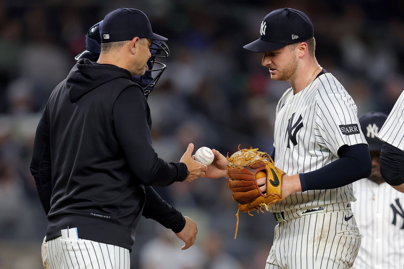 New York Yankees starting pitcher Clarke Schmidt (36) is taken out of the game by manager Aaron Boone (17) during the eighth inning against the Los Angeles Angels at Yankee Stadium.
