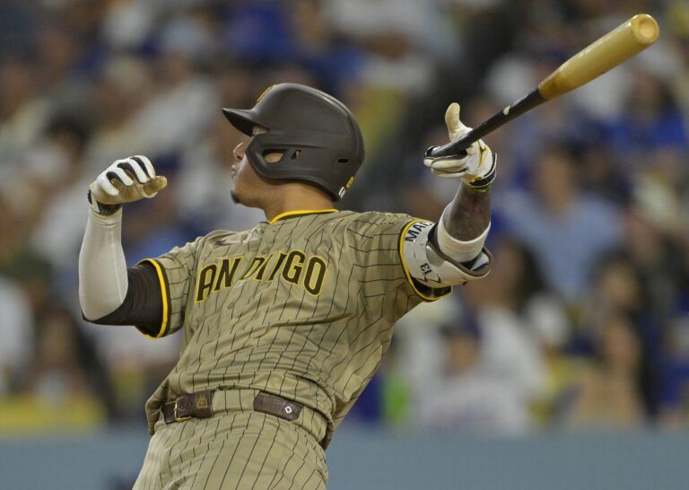 San Diego Padres third baseman Manny Machado (13) flips his bat after hitting a solo home run in the sixth inning against the Los Angeles Dodgers at Dodger Stadium.