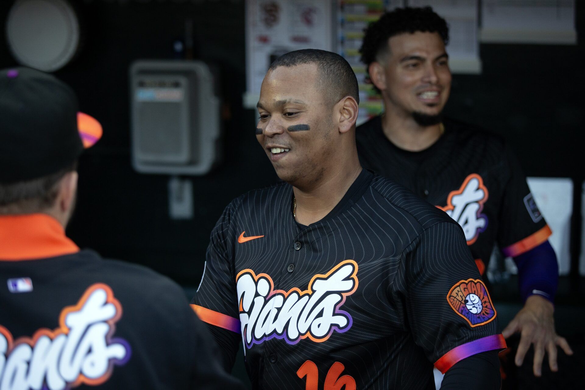 San Francisco Giants designated hitter Rafael Devers (16) greets his new teammates in the dugout before taking on the Cleveland Guardians during the first inning at Oracle Park.