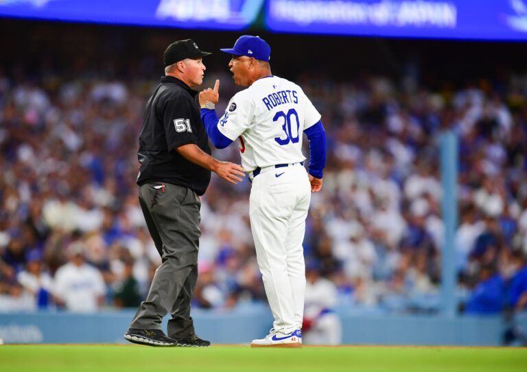 Los Angeles Dodgers manager Dave Roberts (30) argues with umpire Marvin Hudson (51) during the third inning against the San Diego Padres at Dodger Stadium.
