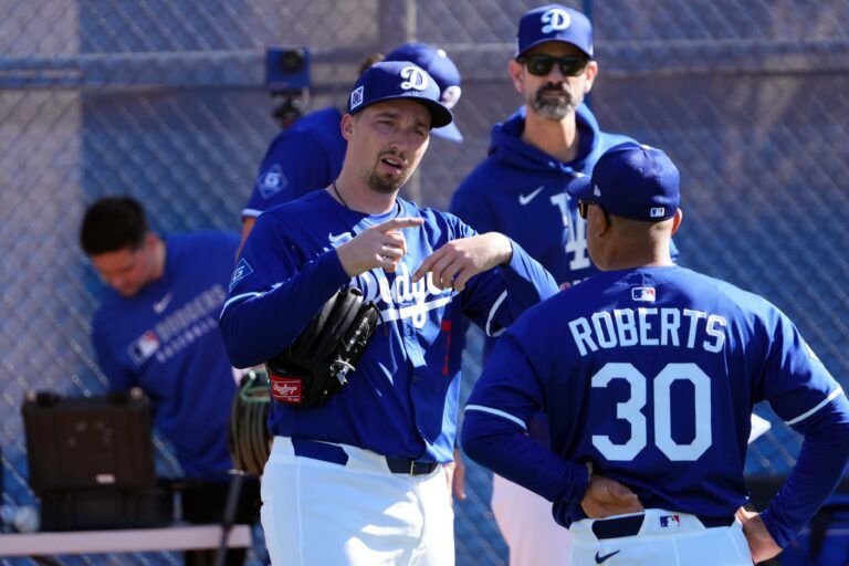 Los Angeles Dodgers pitcher Blake Snell (7) talks with manager Dave Roberts during a Spring Training workout at Camelback Ranch.