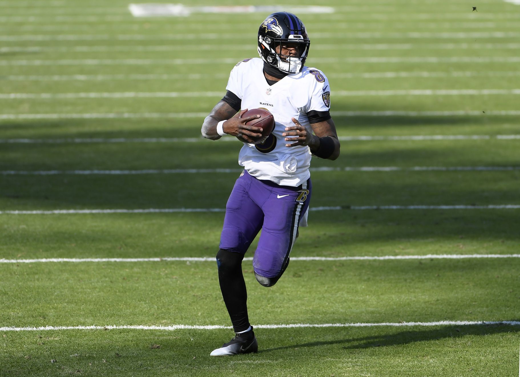 Baltimore Ravens quarterback Lamar Jackson (8) runs with the ball against the Tennessee Titans during the first half in a AFC Wild Card playoff game at Nissan Stadium.